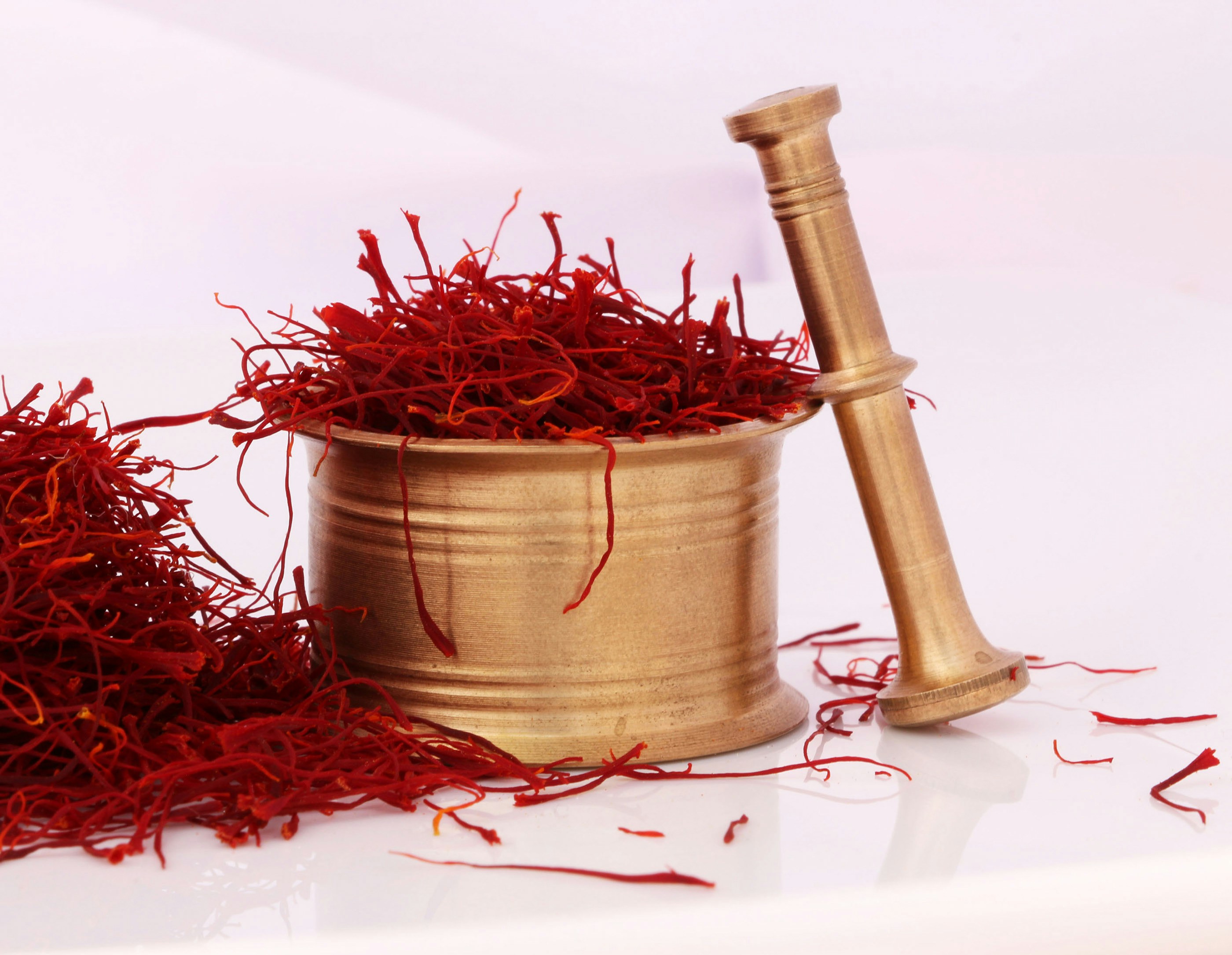 Saffron threads in brass mortar and pestle